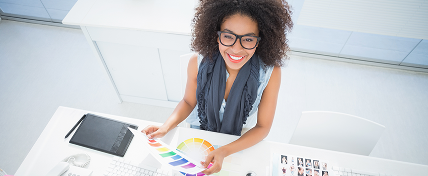 Female looking at colors and smiling with glasses on,